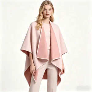 Detail view of pink wool poncho with contrast lining and exquisite edge stitching