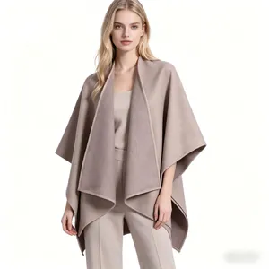 Detail of elegant beige oversized shawl coat featuring wide lapels and loose minimalist style