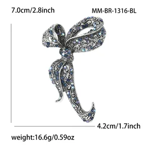 Detailed view of luxury bow brooch with dimensions 7.0x4.2cm and rhinestone inlay