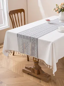 Detailed macro of thick textured tablecloth with gray-blue pattern and elegant tassels