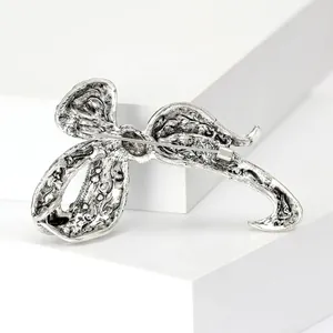 Back view of vintage silver bow brooch showing secure pin clasp and engraved texture