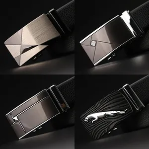 Detail of four metal alloy automatic belt buckles with brushed and embossed finishes