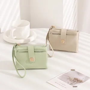 Detailed view of litchi grain texture and card slots on stylish women's mini wallet