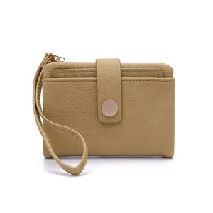 Detail showing khaki lychee pattern leather short wallet with card slots and snap button