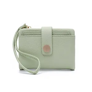 Close-up of mint green lychee pattern PU leather wallet with hand strap and card slots