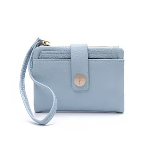Close-up of light blue lychee pattern PU leather wallet with wristlet and gold metal buckle