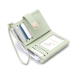 Detail view of mint green PU leather wallet showing card slots and wrist strap