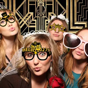 Detail of 2027 New Year party glasses in black and gold glitter with festive patterns