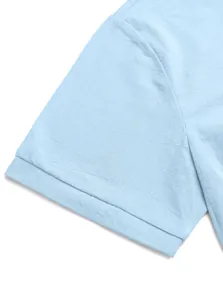 Close-up of light blue linen polo shirt sleeve showing detailed sewing and fabric texture