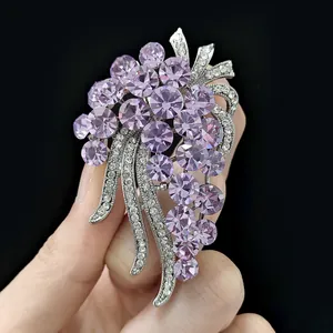Macro detail of grape-shaped silver brooch with purple crystals and zircons