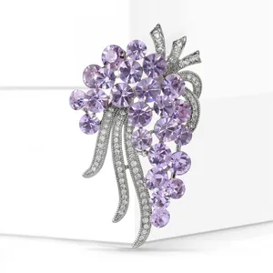 Macro shot of silver grape brooch with purple crystals and cubic zirconia leaves