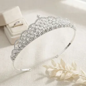 Elegant silver crystal bridal crown for weddings and banquets on a beige fabric background