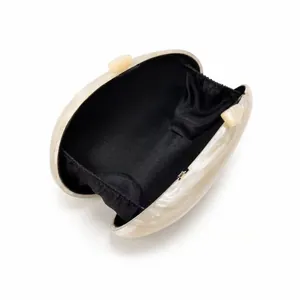Oval acrylic clutch bag with cream marble texture and black satin interior lining
