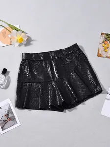 Close-up of black faux crocodile leather skort with glossy embossed texture and A-line cut