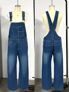 Detail of dark blue washed denim overalls showing bib pockets and X-back straps