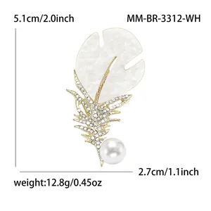 Elegant gold feather brooch with white rhinestones, enamel inlay, and a round pearl charm