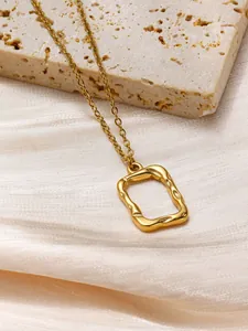 Detailed close-up of golden stainless steel necklace with hammered texture pendant
