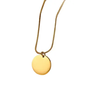 Minimalist gold snake chain necklace featuring a polished round disc pendant