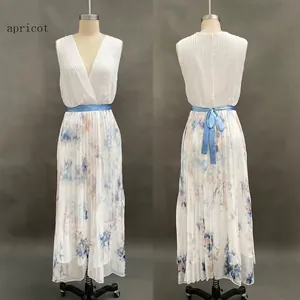Detail of elegant sleeveless deep V-neck pleated maxi dress with blue satin belt