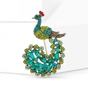 Luxurious peacock brooch with green and blue crystals on elegant white steps