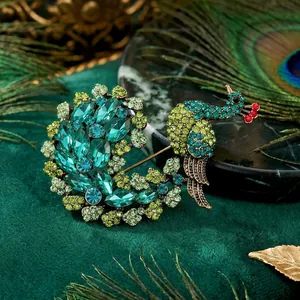Luxurious peacock brooch with vibrant emerald green crystals on dark velvet