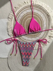 Detailed view of pink halter bikini top with woven straps and size S wash label
