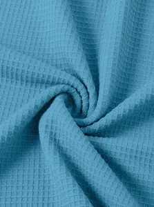 Close-up of premium blue waffle weave fabric texture on men's drawstring hoodie