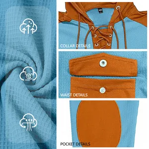 Detailed close-up of waffle knit texture, collar drawstring and snap pockets on hoodie