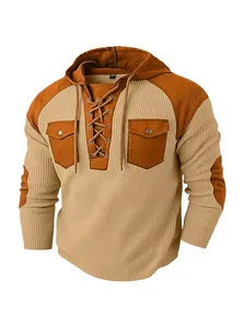Close-up of waffle knit texture and contrast patches on men's khaki hoodie shirt
