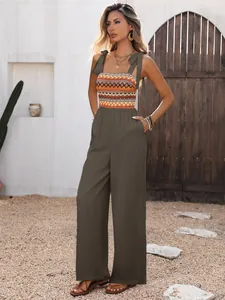 Detail of bohemian jumpsuit with ethnic print bodice, bow straps and side pockets