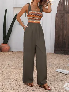 Close-up of bohemian jumpsuit featuring a patterned bodice, tied straps and side pockets
