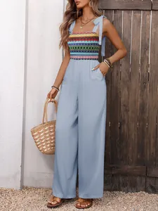 Detail of bohemian summer jumpsuit showing colorful tribal embroidery and drawstring straps