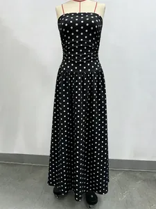 Macro detail of high waist pleats and polka dot pattern on the elegant maxi dress