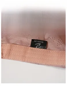 Macro detail of the wide sweatband and breathable laser-cut holes on the pink cap