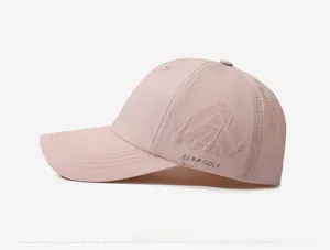 Close-up of pink quick-dry golf cap showing laser-cut triangle ventilation holes