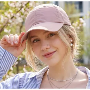 Detail of pink lightweight quick-dry golf cap with laser-cut side vents and logo