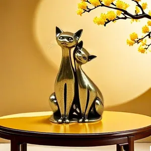 Close-up of abstract long-necked brass cat sculptures with vintage bronze finish