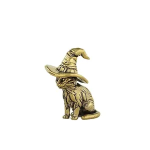 Detailed view of miniature brass cat figurine with wizard hat and antique gold texture