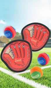 Close-up of Catch and Toss paddle set with velcro sticky balls on green grass