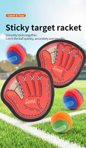 Close-up of palm-shaped sticky racket set with colorful balls on outdoor grass