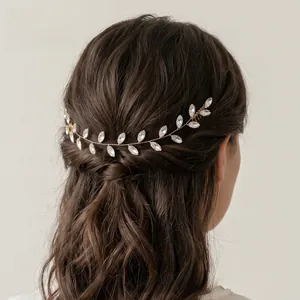 Close-up of handmade bridal rhinestone hair vine with gold wire and marquise crystals