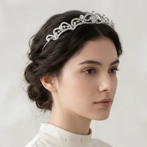 Side view of silver bridal tiara with intricate crystal hollow scroll patterns