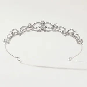 Detailed view of silver bridal crown with intricate scrollwork and sparkling rhinestones