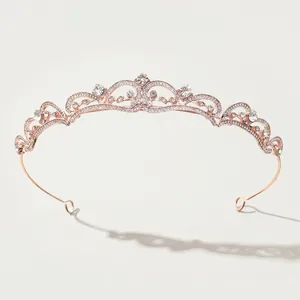 Detail of rose gold bridal crown featuring intricate vine patterns and crystal inlay
