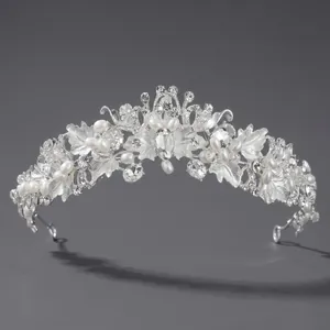 Elegant silver bridal crown with white pearls and sparkling rhinestones in floral design