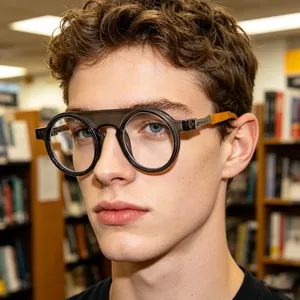 Detail of round frame sunglasses featuring bold orange contrast on the temple arms