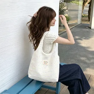 Detail of the woven fabric texture and colorful stripe patterns on a large tote bag