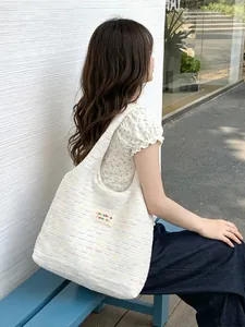 Chic knit tote bag with colorful striped pattern and casual shoulder carry style