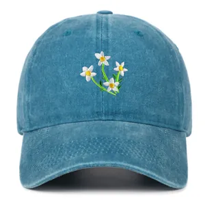 Washed blue baseball cap with daisy embroidery and curved brim for women
