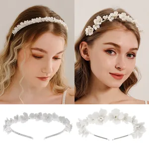 Close-up of white ceramic flowers and tiny beads on bridal headband accessories